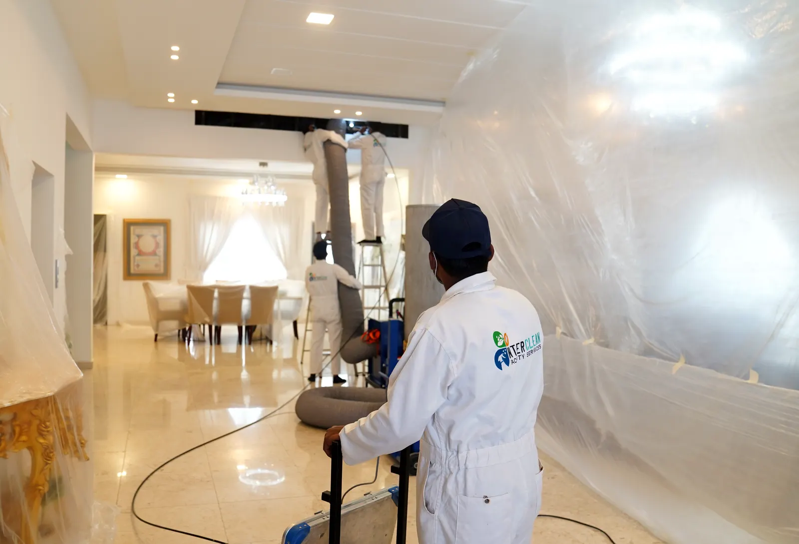 AC duct cleaning with containment sheeting in a Bahrain villa